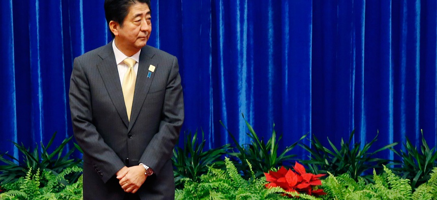 Japan's Prime Minister Shinzo Abe waits to meet China's President Xi Jinping during their meeting at the Great Hall of the People, on the sidelines of the Asia Pacific Economic Cooperation (APEC) meetings, in Beijing, Nov. 10, 2014.