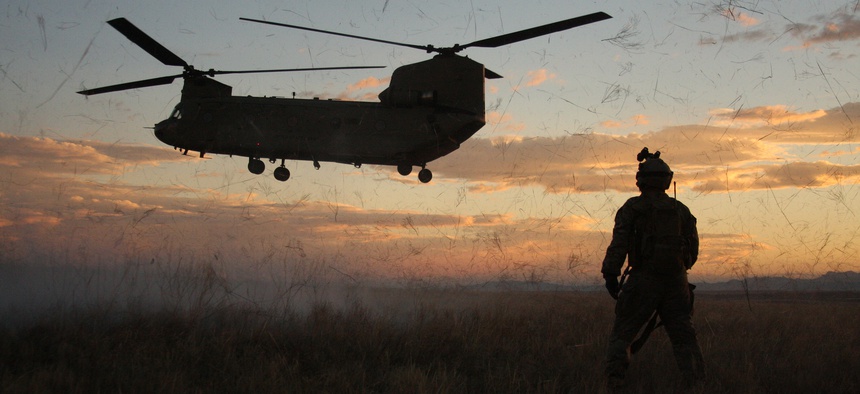 Soldiers from the 4th Aviation Regiment posture for a night air assault raid during a training exercise in Guernsey, Wyoming.