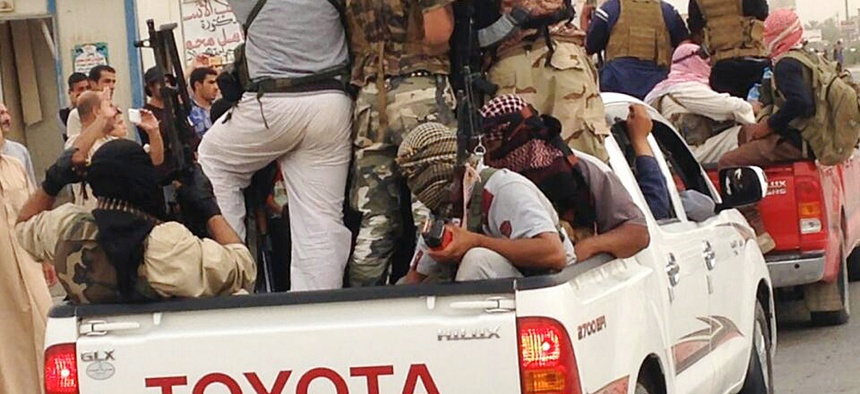 ISIS militants parade in Beiji, 155 miles north of Baghdad, Iraq.