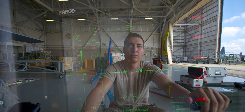 An Airman from Cannon Air Force Base sits at the control module of an MQ-9 Reaper at Hurlburt Field, Fla., April 23, 2014.