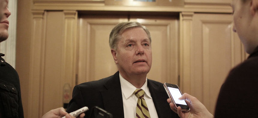 Sen. Lindsey Graham speaks to reporters on Capitol Hill after a vote on a $1.1 trillion spending bill to fund the government through the next fiscal year. 