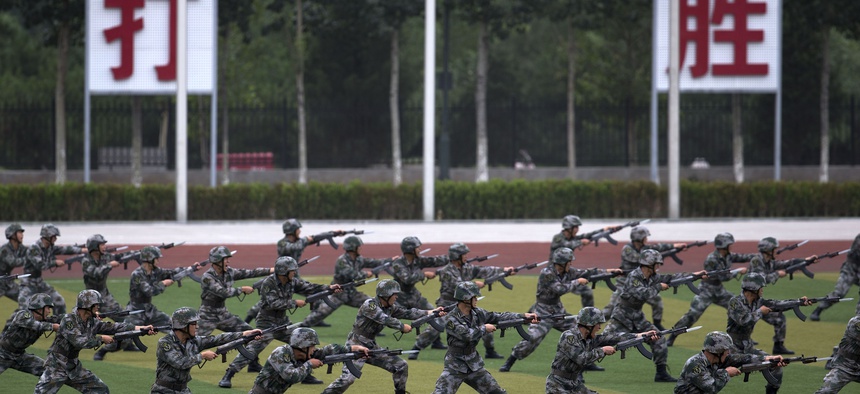 Chinese People's Liberation Army cadets take part in bayonet drills at the PLA's Armoured Forces Engineering Base, in Beijing, China, on July 22, 2014.