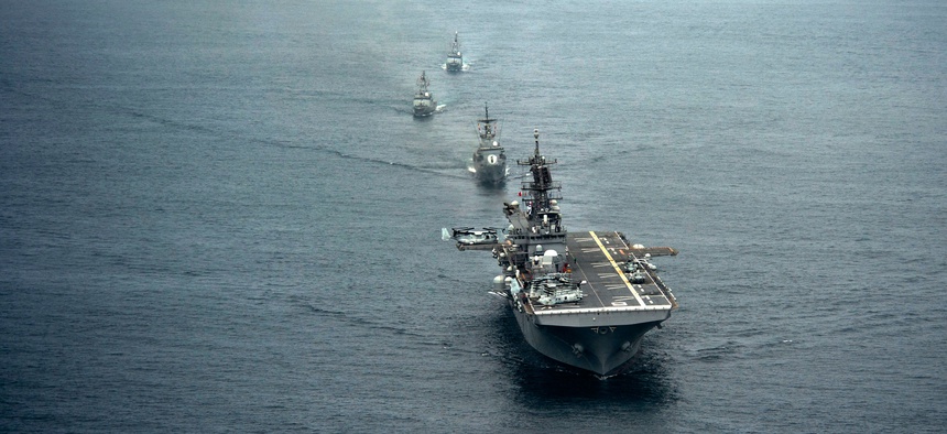 The future USS America and ships from the Peruvian navy sail in formation during a passing exercise in the Pacific Ocean.