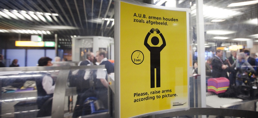 In this Dec. 28, 2009 file photo, an instruction sign is seen inside a body scanner at Schiphol airport, Netherlands.