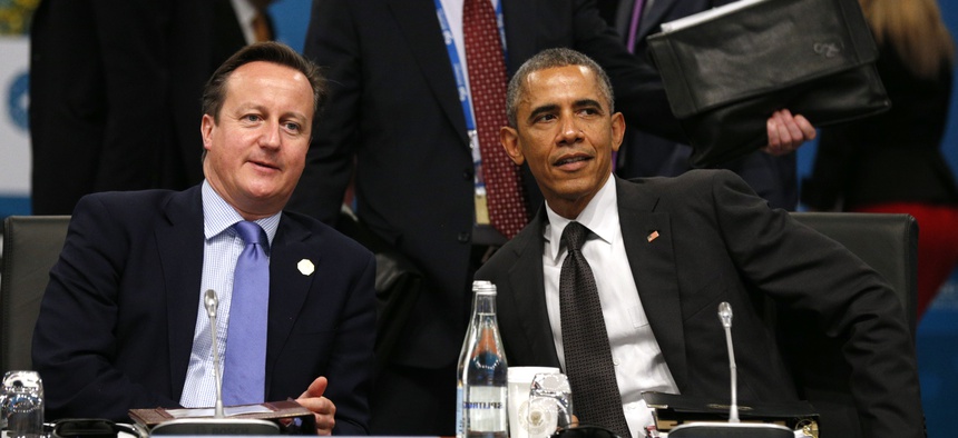 President Barack Obama and British Prime Minister David Cameron talk at the start of the plenary session at the G20 Summit in Brisbane, Australia, on November 15, 2014.
