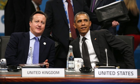 President Barack Obama and British Prime Minister David Cameron talk at the start of the plenary session at the G20 Summit in Brisbane, Australia, on November 15, 2014. President Barack Obama and British Prime Minister David Cameron talk at the start of the plenary session at the G20 Summit in Brisbane, Australia, on November 15, 2014.