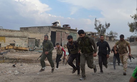 Members of the Free Syrian Army run at the front lines in the town of Sheikh Najjar, in Aleppo, Syria, on June 10, 2014. Members of the Free Syrian Army run at the front lines in the town of Sheikh Najjar, in Aleppo, Syria, on June 10, 2014.