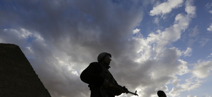 An Egyptian policeman stands alert at the historical site of the Pyramids, on January 16, 2015.