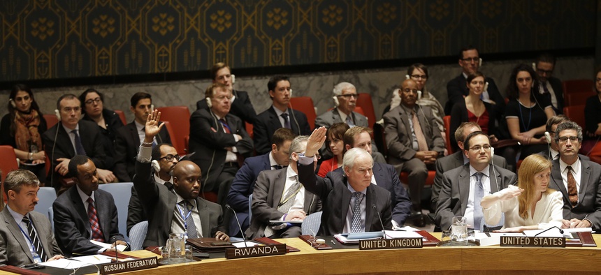Members of the UN Security Council vote in favor of putting North Korea's human rights situation on the council's agenda during a meeting on Dec. 22, 2014.