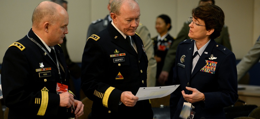 Joint Chiefs Chairman Gen. Martin Dempsey receives a brief from USAF Brig. Gen. Jacqueline Van Ovost, on January 22, 2015.