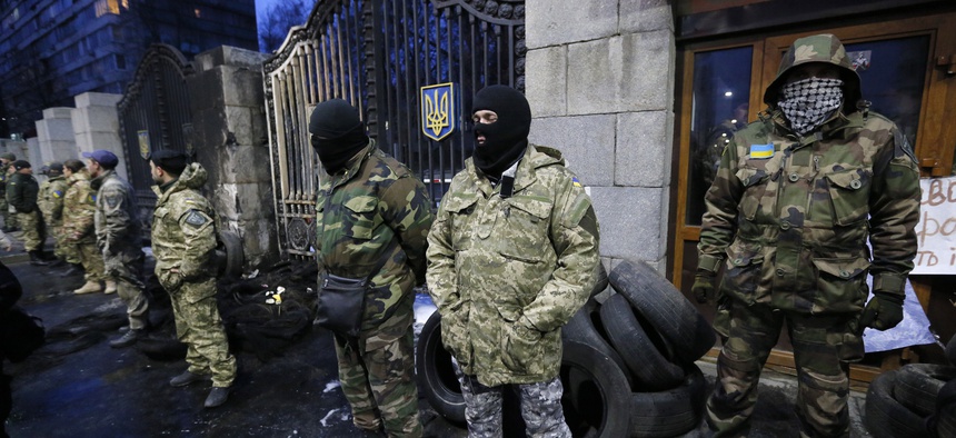 Volunteers of the Aidar battalion picket in front of the Ministry of Defense as they protest against a decision to change the leadership of the battalion in Kiev, Ukraine, Monday, Feb. 2, 2015.