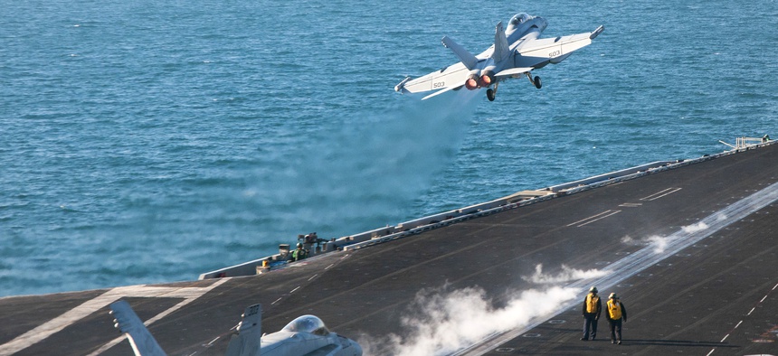 An EA-18G Growler launches from the flight deck of the aircraft carrier USS Carl Vinson as it conducts operations to target ISIS, on January 30, 2015.