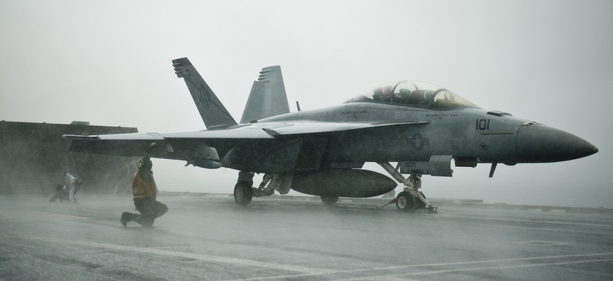 Sailors conduct pre-flight checks on an F/A-18F Super Hornet assigned to Strike Fighter Squadron 41, aboard the USS John C. Stennis, on Sept. 12, 2011.