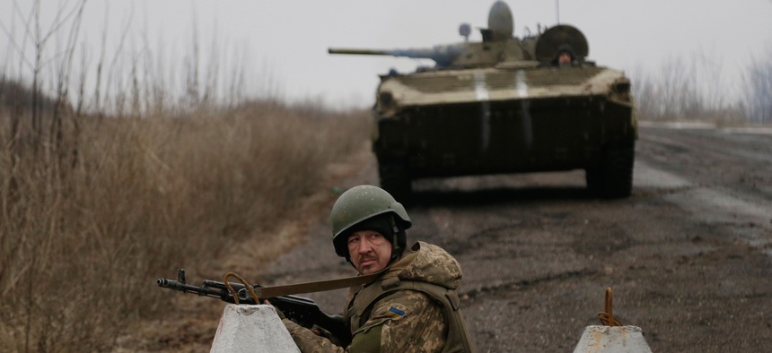 Ukrainian troops guard a roadblock between the towns of Vuhlehirsk and Debaltseve, Ukraine on Friday, Feb. 6, 2015.