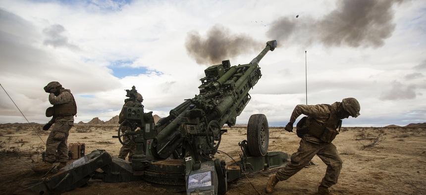 Marines with the 12th Marines fire a M77-A2 Howitzer down range during an Integrated Training Exercise 2-15, at Camp Wilson, Marine Corps, on January 31, 2015.