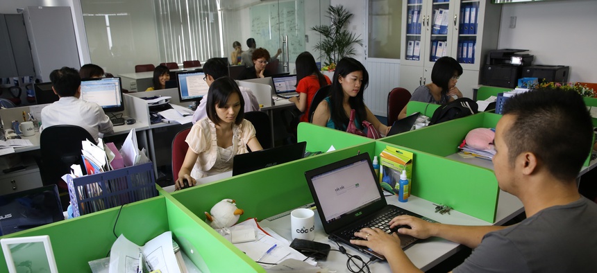 Staff work at a newly launched Russian- Vietnamese web company which is developing its search engine technology.