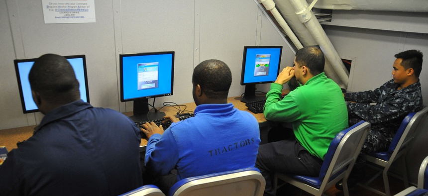 Sailors aboard the USS Carl Vinson use computers in the Learning Media Resource Center to check email from friends and loved ones.