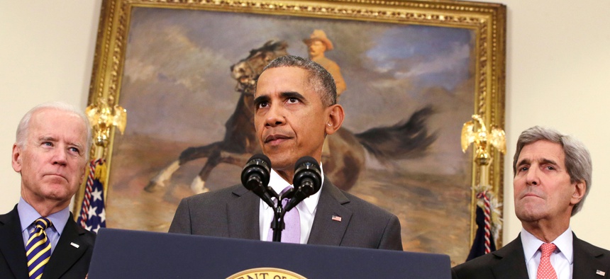 President Barack Obama, flanked by Vice President Joe Biden, left, and Secretary of State John Kerry, right, speaks about the Islamic State group in the Roosevelt Room of the White House in Washington, Feb. 11, 2015.