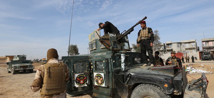 Iraqi security forces deploy to regain control of the villages surrounding the town of Beiji, 155 miles north of Baghdad, Iraq, on Dec. 8, 2014.