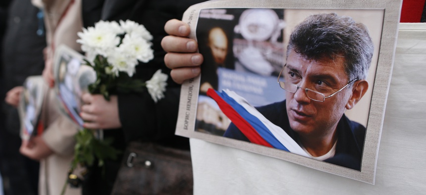 People march in the memory of Russian opposition leader Boris Nemtsov, during a demonstration in Vilnius, Lithuania.