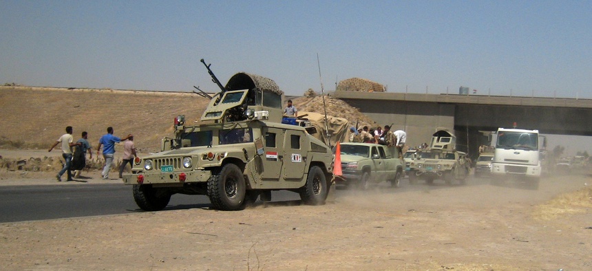 Iraqi security forces head to Baghdad on the main road between Baghdad and Mosul, on June 11, 2014.