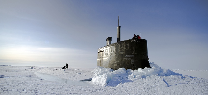 Sailors and members of the Applied Physics Laboratory Ice Station clear ice from the hatch of the USS Conecticutt, on March 19, 2011.