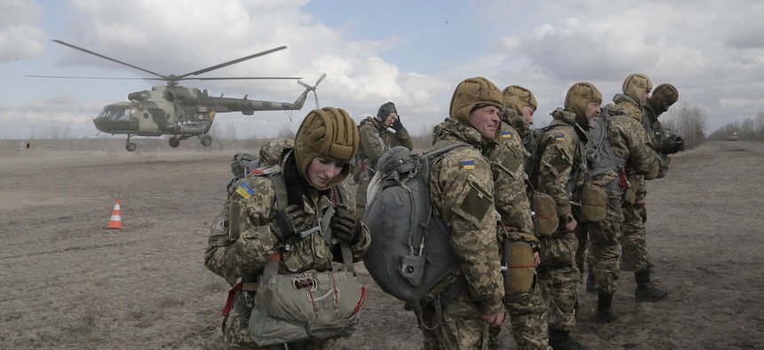 Ukrainian army soldiers perform a military exercise at a training ground outside Zhitomir, Ukraine, Friday, March 6, 2015.