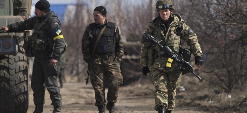 Ukrainian servicemen walk at a front line position east of the Sea of Azov port city, Mariupol, Ukraine, on March 10, 2015.