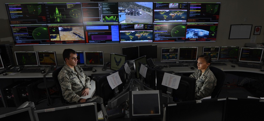 Two airmen work in the Global Strategic Warning and Space Surveillance System Center at Cheyenne Mountain Air Force Station, Colo., on Sept. 2, 2014.