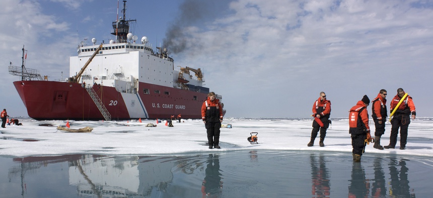 Scientists and Coast Guard swimmers test a melt pond in the Chukchi Sea on July 9, 2010.
