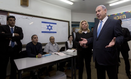 Israeli Prime Minister Benjamin Netanyahu stands with his wife Sara as he speaks to the media, after voting in Israel's parliamentary elections in Jerusalem, Tuesday, Mar. 17, 2015. Israeli Prime Minister Benjamin Netanyahu stands with his wife Sara as he speaks to the media, after voting in Israel's parliamentary elections in Jerusalem, Tuesday, Mar. 17, 2015.