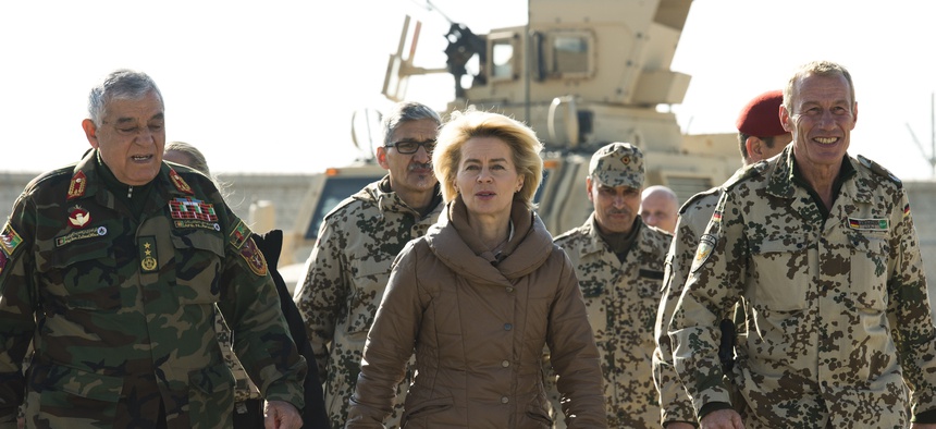 German defense minister Ursula von der Leyen walks with Afghan Maj. Gen. Zalmai Wesa during a visit to CAmp Shaheen, on Dec. 13, 2014.