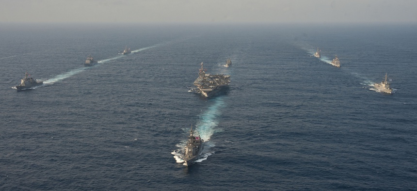 Ships from the USS George Washington Carrier Strike Group, the Japanese Maritime Self-Defense Force and the Republic of Korea Navy sail during a trilateral exercise in the East China Sea, on June 22, 2012.