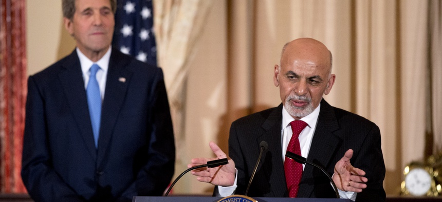 Afghan President Ashraf Ghani speaks while Secretary of State John Kerry listens during a dinner reception at the State Department, on March 24, 2015.