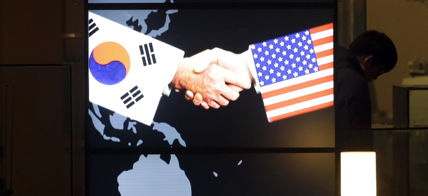 Seen here, the screen showing an image of a handshake by the U.S. and South Korean flags, on Jan. 14, 2015.