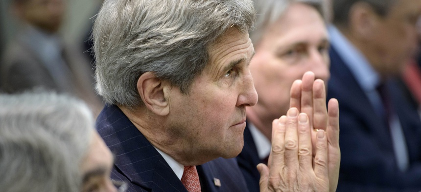 U.S. Secretary of State John Kerry waits with others before a meeting with Britain, Russia, China, France, Germany, European Union and Iranian officials at the Beau Rivage Palace Hotel in Lausanne, Switzerland Monday, March 30, 2015.