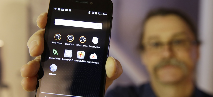Silicon Valley pioneer and Silent Circle co-founder Jon Callas holds up Blackphone with encryption apps displayed on it at the Computer History Museum in Mountain View, Calif.