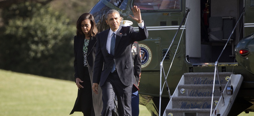 President Barack Obama waves as he walks across the South Lawn of the White House with first lady Michelle Obama in Washington, Monday, March 30, 2015.