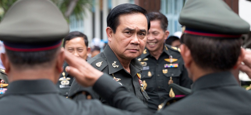 Thailand's new Prime Minister Prayuth Chan-ocha, center, arrives for an establishment anniversary of the 21st infantry regiment, Queen's Guard in Chonburi Province, Thailand, Aug. 21, 2014.