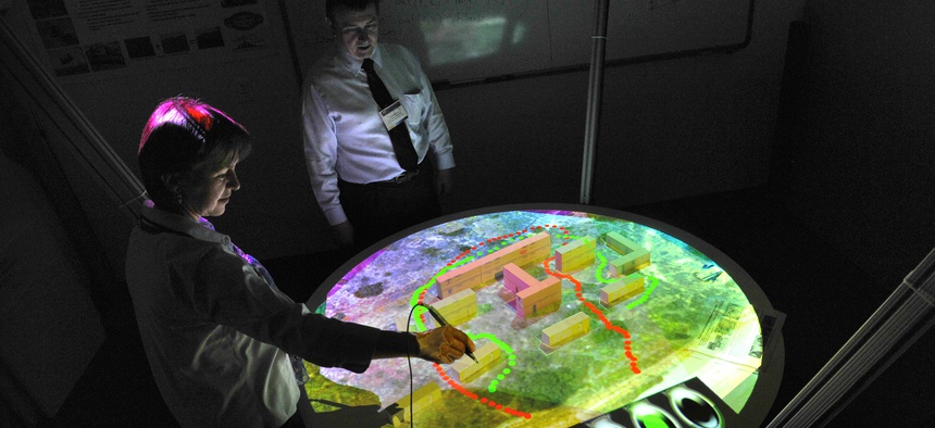 A research associate professor at the Naval Postgraduate School demonstrates the virtual sand table for urban warfare operations training rehearsals at Monterey, Calif., July 22, 2009.