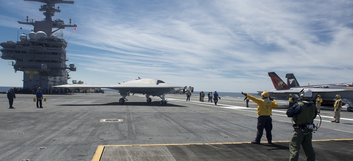 An X-47B Unmanned Combat Air System (UCAS) demonstrator taxies on the flight deck of the aircraft carrier USS George H.W. Bush (CVN 77). 