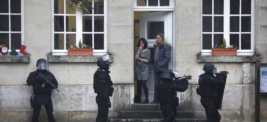 In this Jan.8, 2015 file photo, French police officers patrol in Longpont, north of Paris, France, Thursday, Jan. 8, 2015 in the search for the two suspects in the Charlie Hebdo killing.