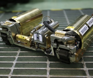 In this Thursday, Feb. 5, 2015 photo, a robot that looks like an enlarged fiberscope is controlled during a demonstration for the media at a government facility in Hitachi, Ibaraki Prefecture, northeast of Tokyo. 