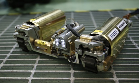 In this Thursday, Feb. 5, 2015 photo, a robot that looks like an enlarged fiberscope is controlled during a demonstration for the media at a government facility in Hitachi, Ibaraki Prefecture, northeast of Tokyo. 