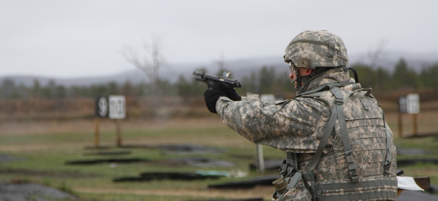 A specialist with the 533rd Brigade Support Battalion competes in a 9mm pistol course at the Best Warrior Competition at Fort McCoy, Wisc., on April 29, 2014.