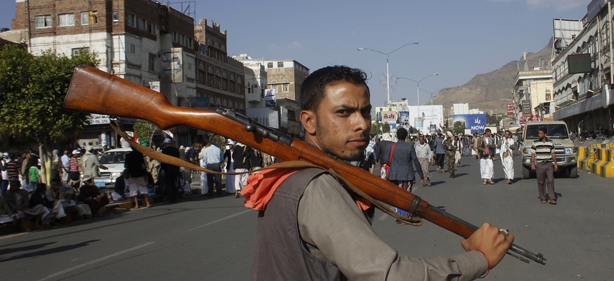A Houthi Shiite rebel carries his weapon as he joins others to protest against Saudi-led airstrikes, during a rally in Sanaa, Yemen, Wednesday, April 1, 2015.