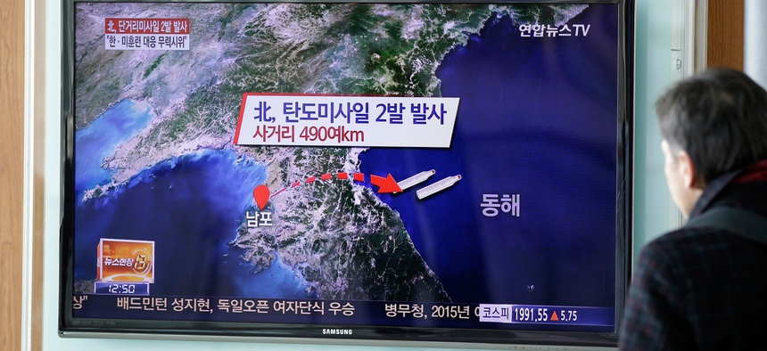 A man watches a TV news program reporting that North Korea fired two short-range ballistic missiles, at Seoul Railway Station in Seoul, South Korea, Monday, March 2, 2015.