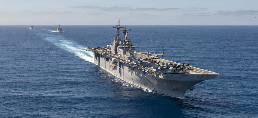 The Wasp-class amphibious assault ship USS Essex (LHD 2), front, the Whidbey Island-class amphibious dock landing ship USS Rushmore (LSD 47) and the San Antonio-class amphibious transport dock ship USS Anchorage conduct a simulated strait transit.
