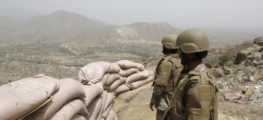 Saudi soldiers stand guard from behind a sandbag barricade at the border with Yemen in Jazan, Saudi Arabia, Monday, April 20, 2015.