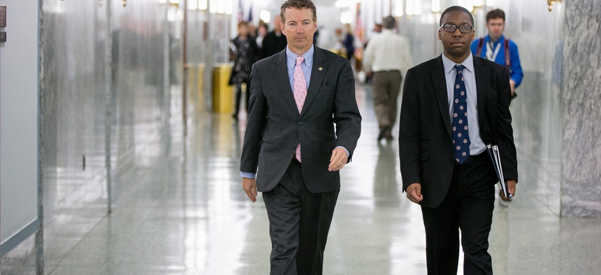Republican Presidential candidate Sen. Rand Paul, R-Ky., center, walks on Capitol Hill in Washington, Wednesday, April 15, 2015.